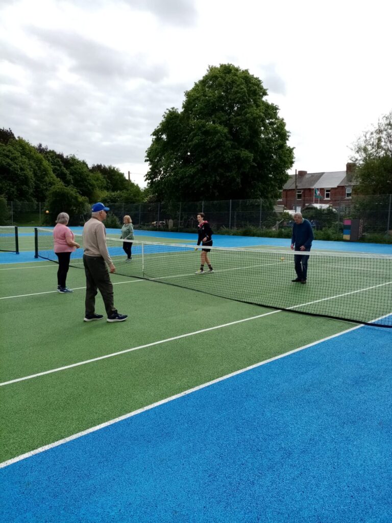 Group on tennis court